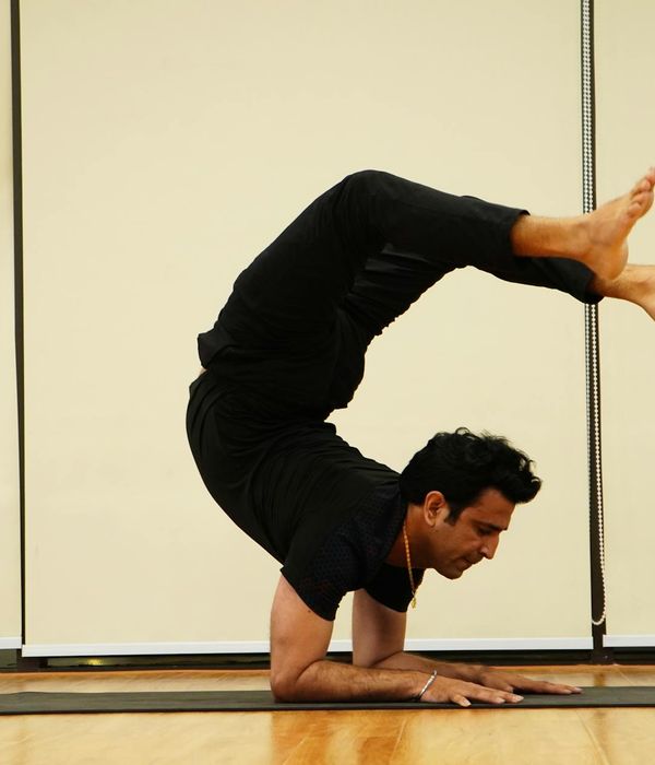 Man performing a controlled strength exercise in a calm, focused environment.